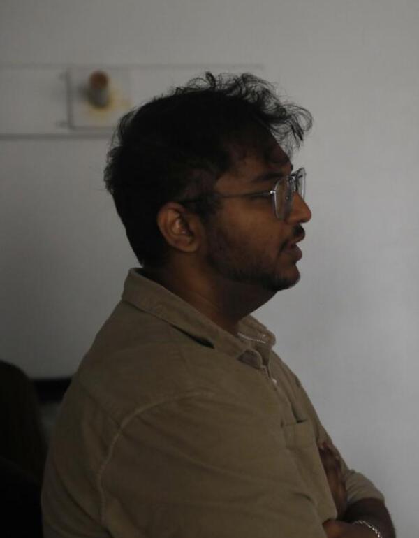 Omkar Mohare, Mumbai-based filmmaker, photographed in side profile wearing clear-framed glasses and a beige polo shirt.