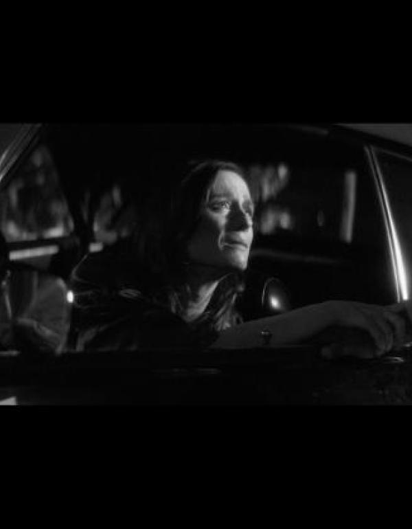 A woman looks out the car window