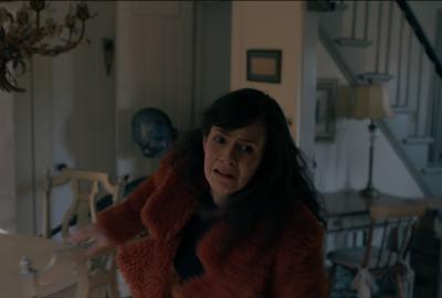 Woman runs through house scared