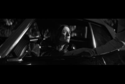 Woman in a car looks out of the window.