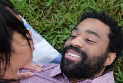 A couple get romantic on the grass