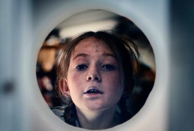 Mia, a 10 year old locked inside a work shed, played by Mani Shanks.