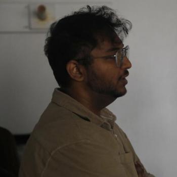 Omkar Mohare, Mumbai-based filmmaker, photographed in side profile wearing clear-framed glasses and a beige polo shirt.