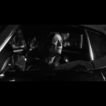 A woman looks out the car window